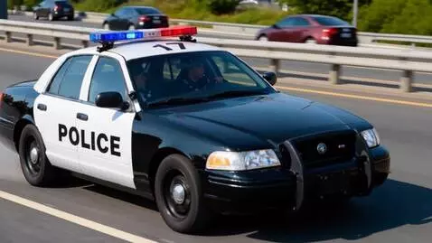 AI Video from prompt: Two Police officers one in the drivers seat and 