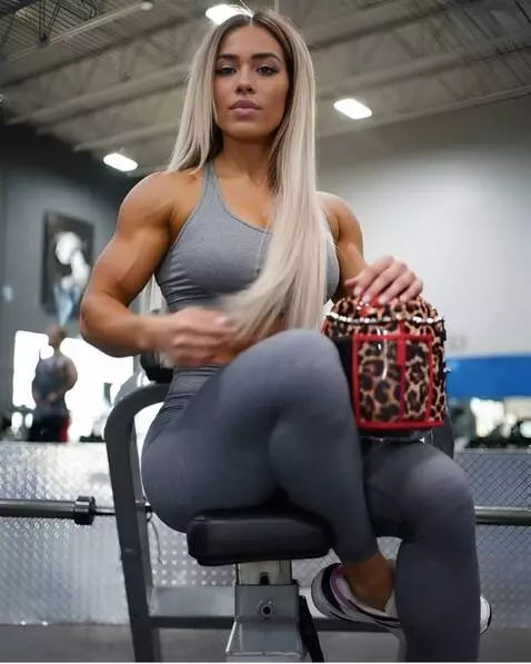 AI Video from prompt: muscular girl in the gym flexes her biceps with 