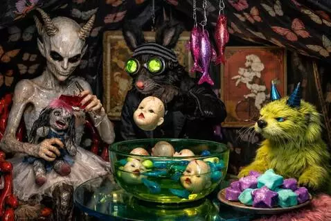 AI Video from prompt: The woman pours a little wine in the doll's mout