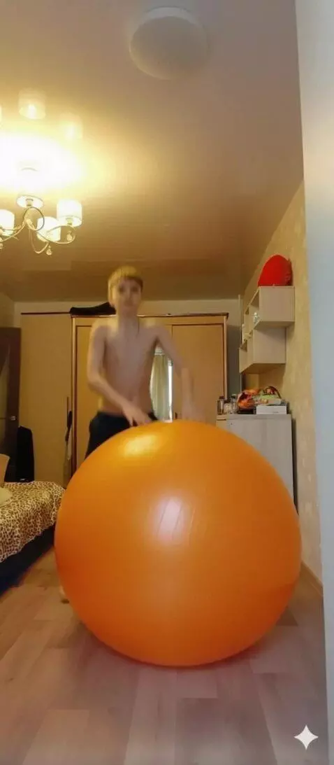 AI Video from prompt: A man sits on an orange fitball and starts jumpi