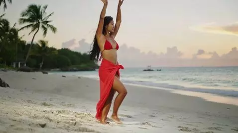 AI Video from prompt: beautiful Asian woman in a bikini dancing