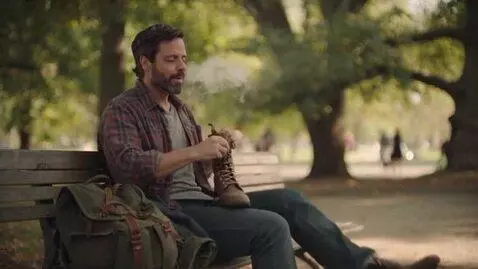 AI Video from prompt: In a bustling city park, a rugged yet kind-eyed 