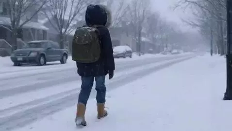 AI Video from prompt: A boy walks down a snowy street