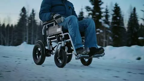 AI Video from prompt: A person in a compact wheelchair with four wheel