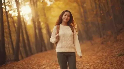 AI Video from prompt: A beautiful girl walks along a forest path, the 