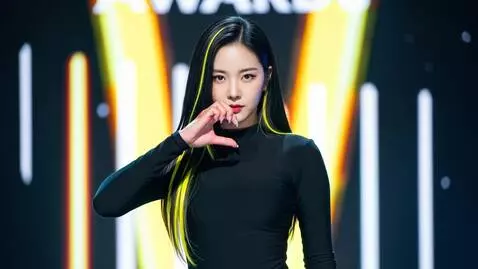 AI Video from prompt: Ending fairy pose: fingers in a heart near chin,