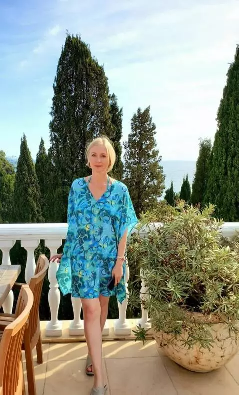 AI Video from prompt: A young woman dressed in a robe walks closer to 