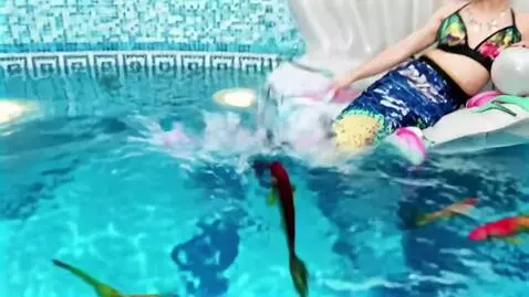 AI Video from prompt: The mermaid waves her tail and dives into the wa