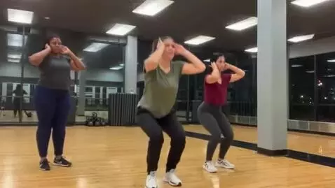 AI Video from prompt: Girls holding ears while standing. Performing de