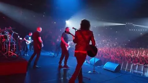 AI Video from prompt: In a packed arena, the electric guitar wailed an