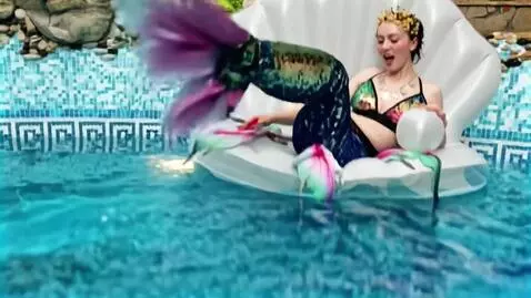 AI Video from prompt: The mermaid dives under the water. The camera fo