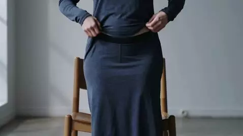 AI Video from prompt: she stands up, lifts her dress high, small swimm