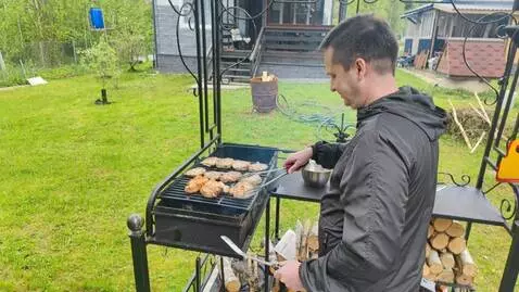 AI Video from prompt: the man takes a piece of meat and feeds it to th