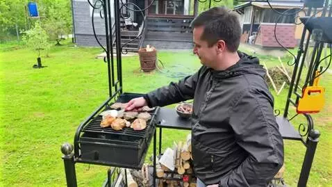 AI Video from prompt: the man takes a piece of meat and feeds it to th