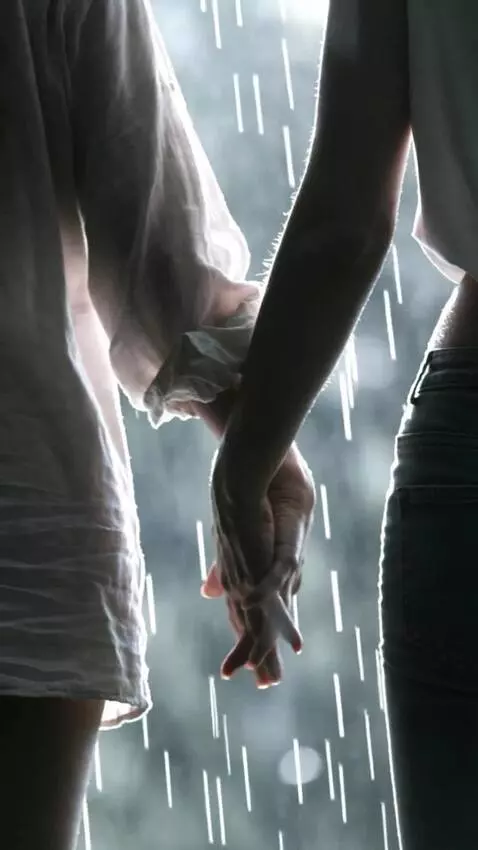 AI Video from prompt: A couple are lovingly holding hands as the rain 