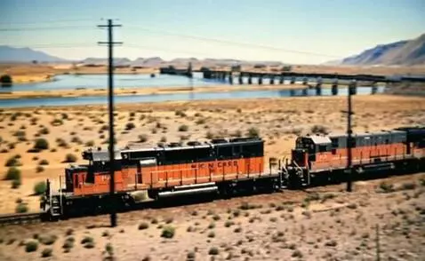 AI Video from prompt: A diesel locomotive with a freight coming on a c