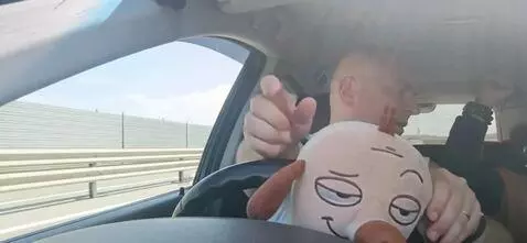 AI Video from prompt: the man puts the toy behind the wheel, everyone 