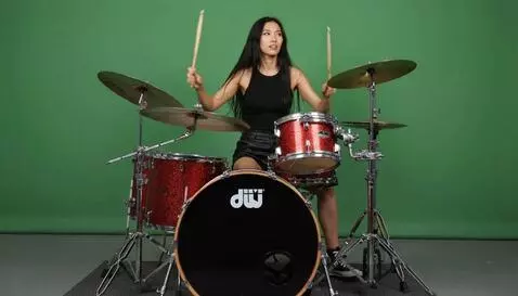 AI Video from prompt: a mixed race Asian girl is playing a sparked red
