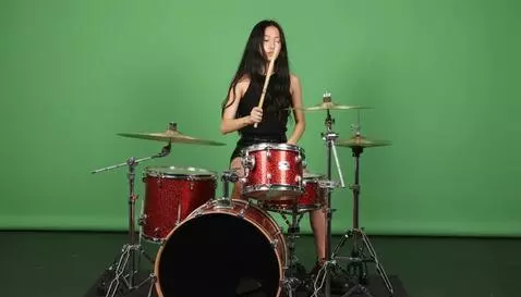 AI Video from prompt: a mixed race Asian girl is playing a sparked red