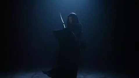 AI Video from prompt: A girl in the dark, wearing a robe and a hood. H