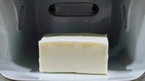 AI Video from prompt: A plain bar of white Ivory soap is placed in the