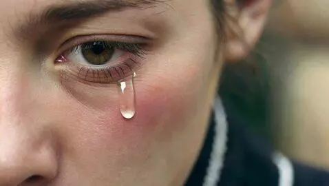 AI Video from prompt: extreme close-up of A single tear falling down a