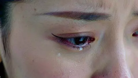AI Video from prompt: extreme close-up of A single tear falling down a