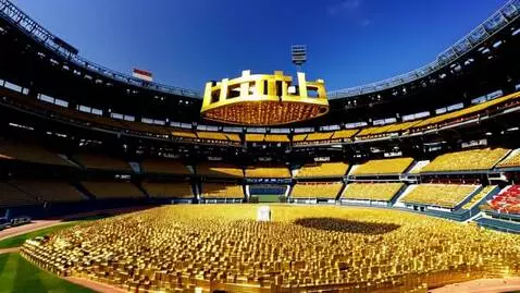 AI Video from prompt: gold bars being stacked in a full baseball stadi