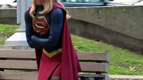 AI Video from prompt: Supergirl sits looking serious