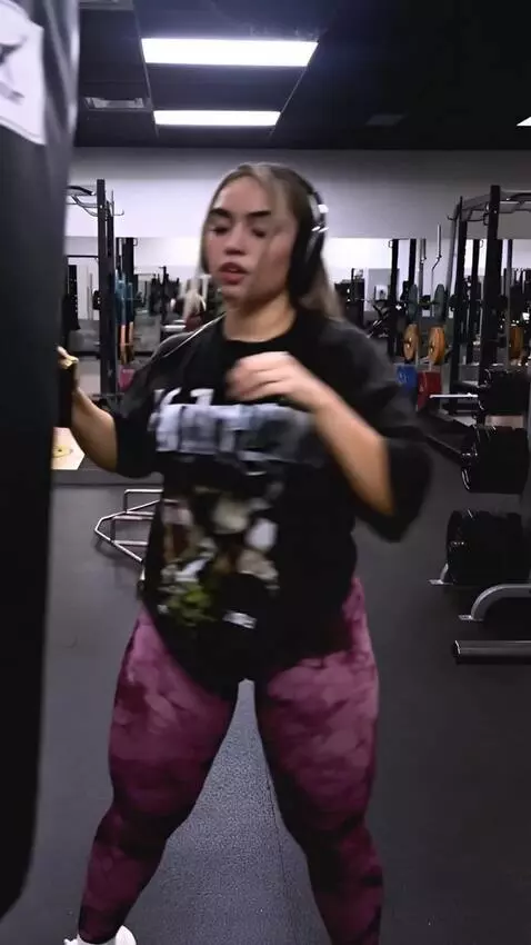 AI Video from prompt: The female boxer punches the bag hard with her f