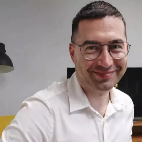 AI Video from prompt: The man on the photo stands up smiling, backgrou