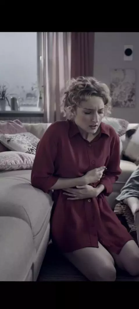 AI Video from prompt: The girl's stomach twisted violently. She's curl