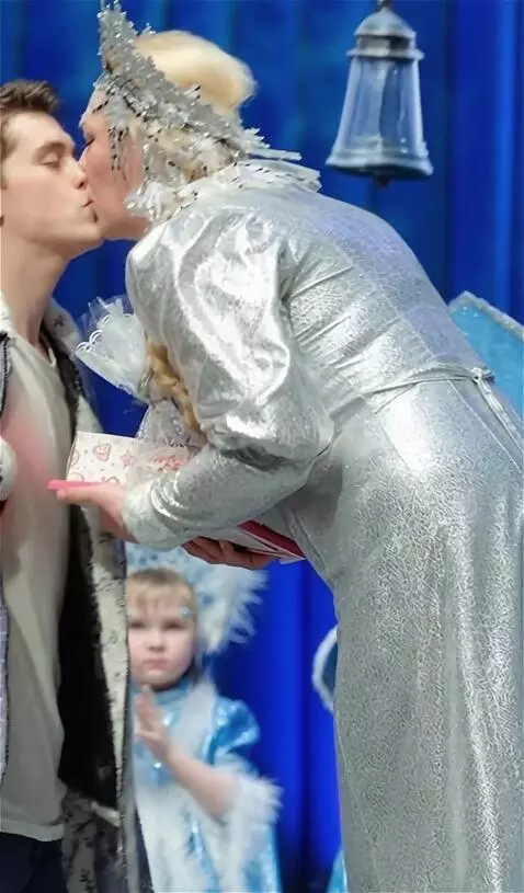 AI Video from prompt: A plump fifty-year-old snow queen kisses a young