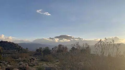 AI Video from prompt: An immense spacecraft appears in the clouds behi