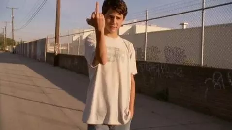 AI Video from prompt: a teenage boy in cut-off jeans flipping the bird