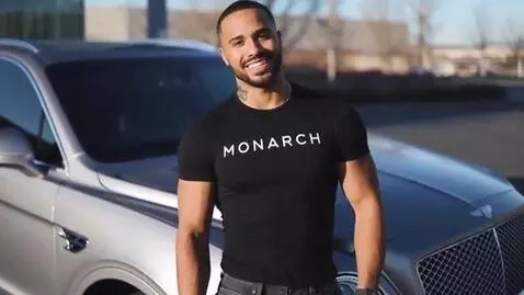 AI Video from prompt: Tough guy got a t-shirt with MONARCH written on 