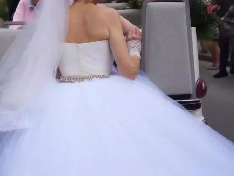 AI Video from prompt: The woman on the left, carrying a girl in a wedd