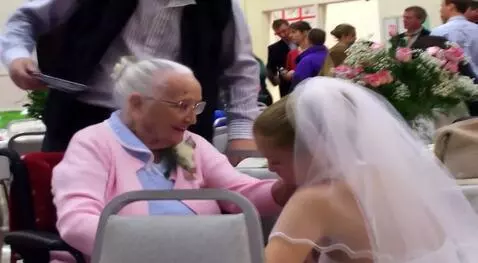 AI Video from prompt: The woman on the left, carrying a girl in a wedd