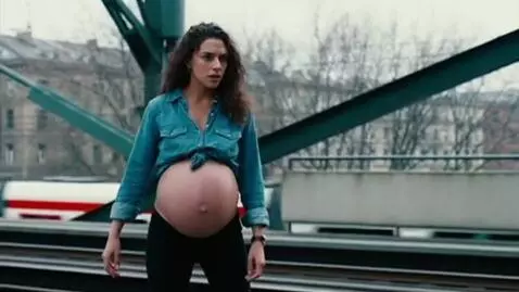 AI Video from prompt: Pregnant woman in a denim shirt with open belly 