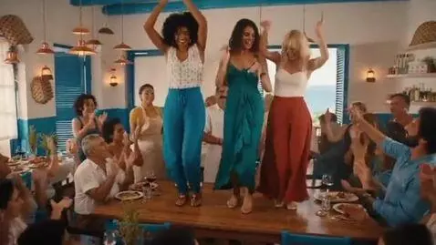 AI Video from prompt: Three women dance on a table top of a Greek rest
