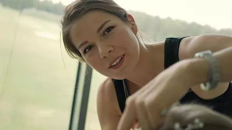 AI Video from prompt: The girl looks at me in the camera and smiles, t