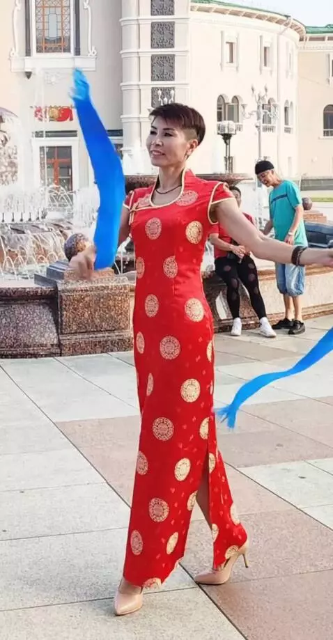 AI Video from prompt: Make sure that the girl in the red dress dances 