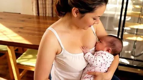 AI Video from prompt: A white mother is breastfeeding her baby