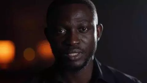 AI Video from prompt: A cinematic close-up of a very serious Nigerian 