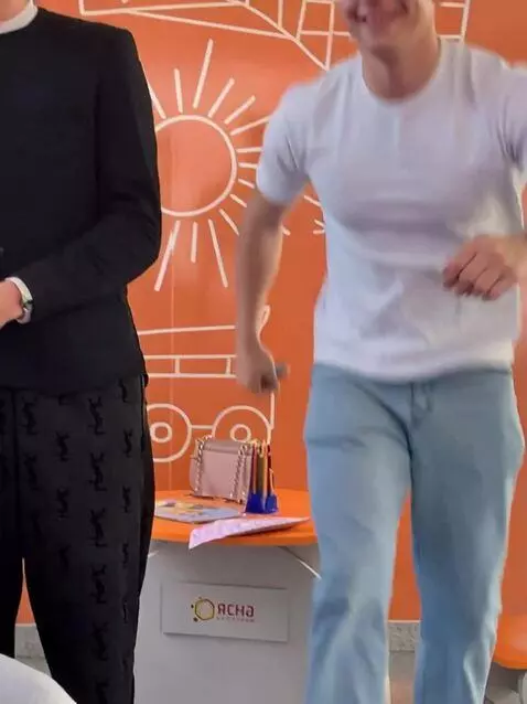 AI Video from prompt: The man in the photo gets up, puts on a nice sui