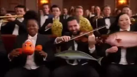 AI Video from prompt: A symphony orchestra performs using fish instead