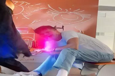 AI Video from prompt: The man in the photo gets up, puts on a nice sui