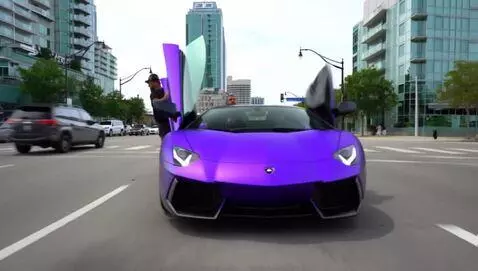 AI Video from prompt: He gets behind the wheel of a purple Lamborghini