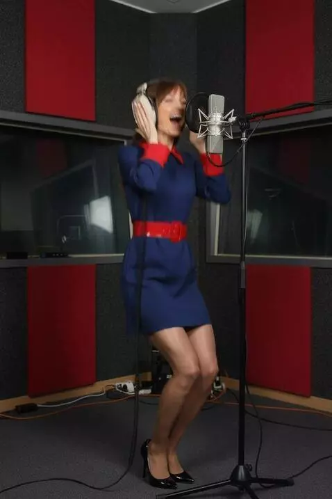 AI Video from prompt: The woman successfully recorded a take,  and hea