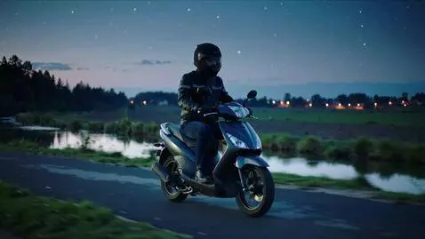 AI Video from prompt: I'm riding a moped on a night road near a long d